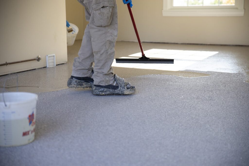 worker apply floor coating